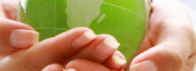 Image of a person cradling a globe of the world, protecting and keeping the world safe and secure.