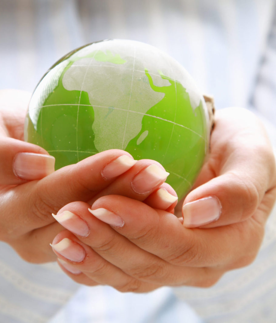 Image of a person cradling a globe of the world, protecting and keeping the world safe and secure.